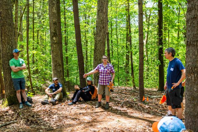 Photo of a group of people taking a break from sculpting the biking trails.